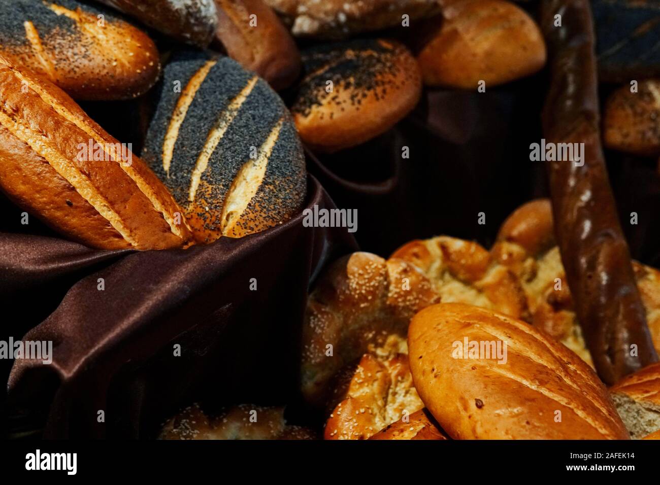 many rolls of different breads in the bakery restaurant Stock Photo
