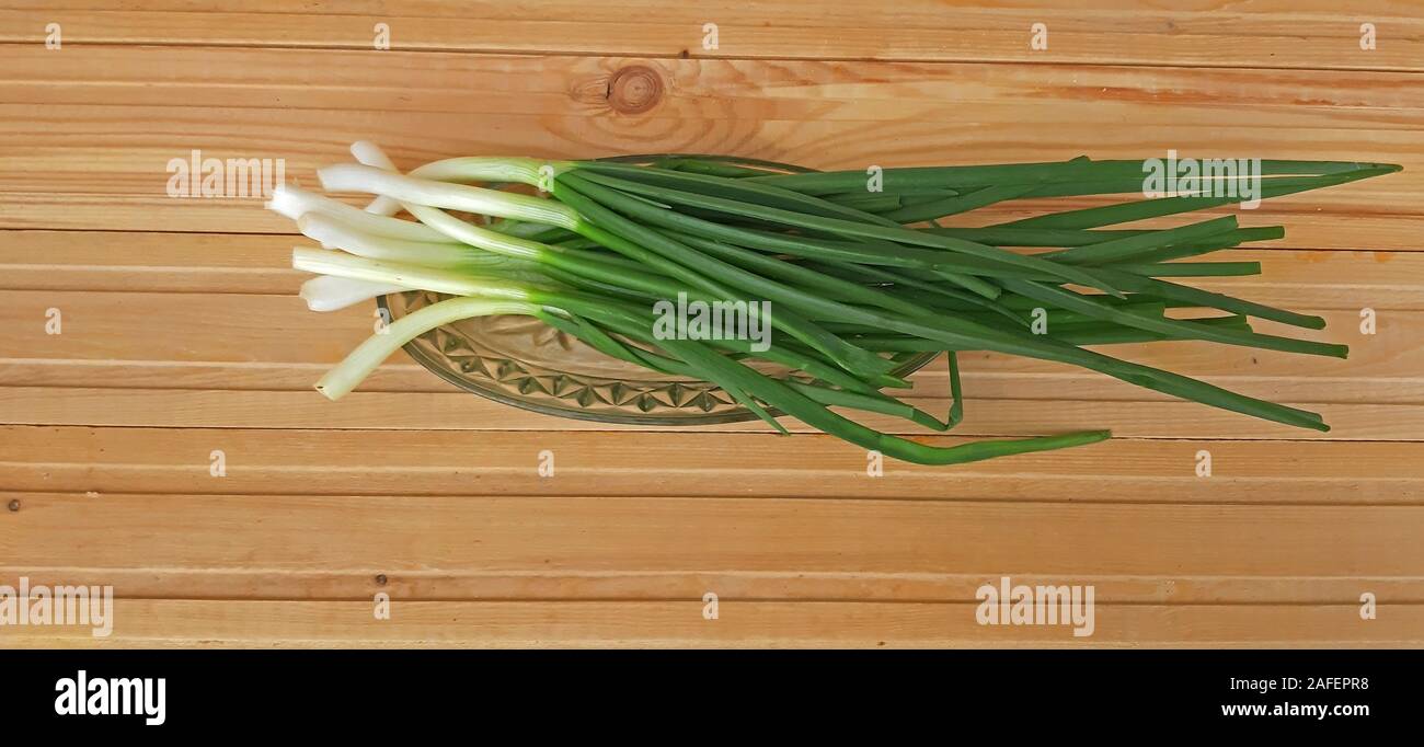 Spring onions and fresh on wooden background Stock Photo
