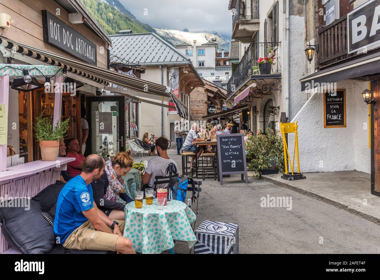 A couple drinks beer outside a restaurant in Chamonix, France. Stock Photo