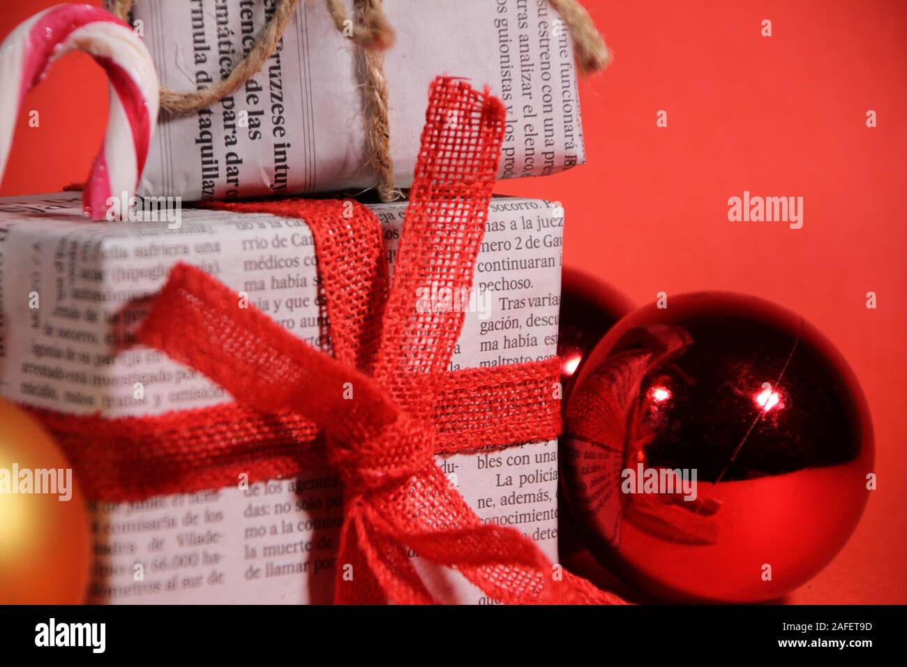 Alicante, Spain December 15, 2019 Gifts wrapped in old newspaper with