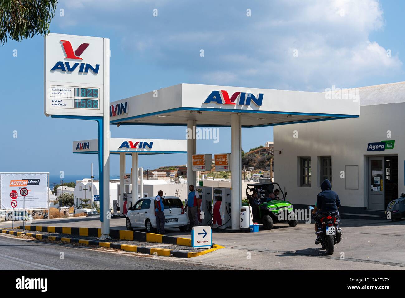 Emporio, Greece - July 17 2019:   A car, bike and four by four buggy on the forecourt of the Avin pertol station on the Fira to Perissa Road Stock Photo