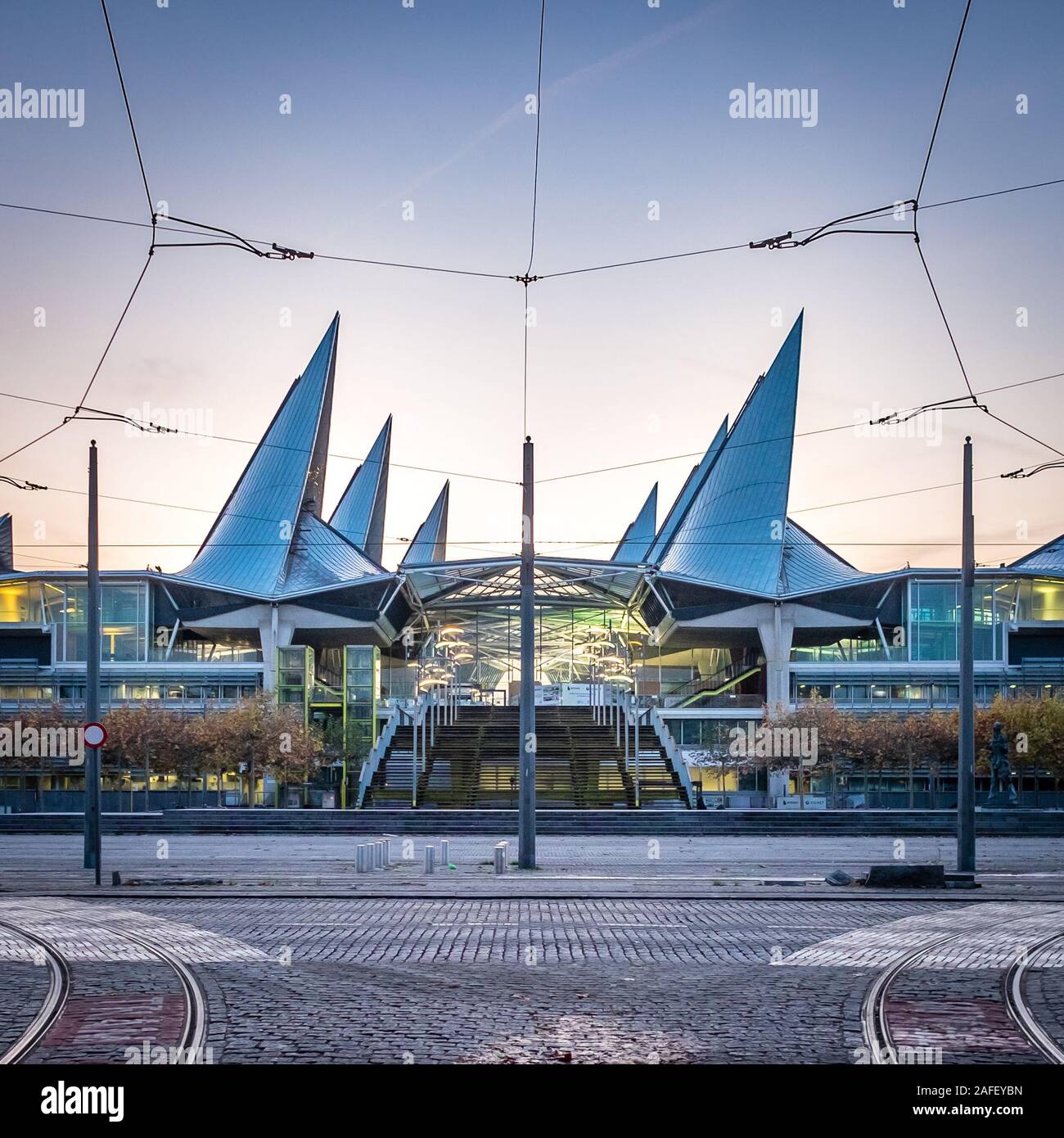 Majestic Antwerp Courthouse after sunset, framed by the overhead lines of the local tram Stock