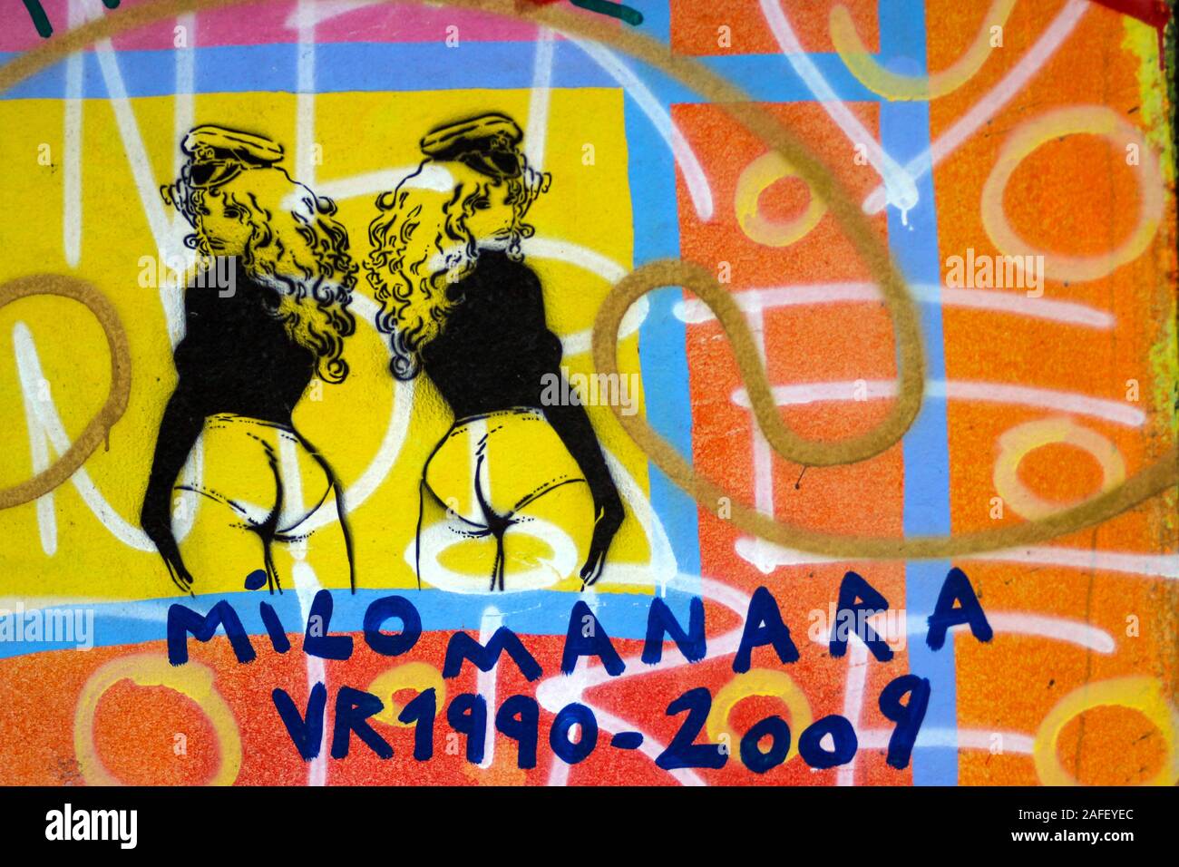 Stencil graffiti art of Milo Manara character on Berlin Wall at East Side Gallery in Berlin, Germany Stock Photo