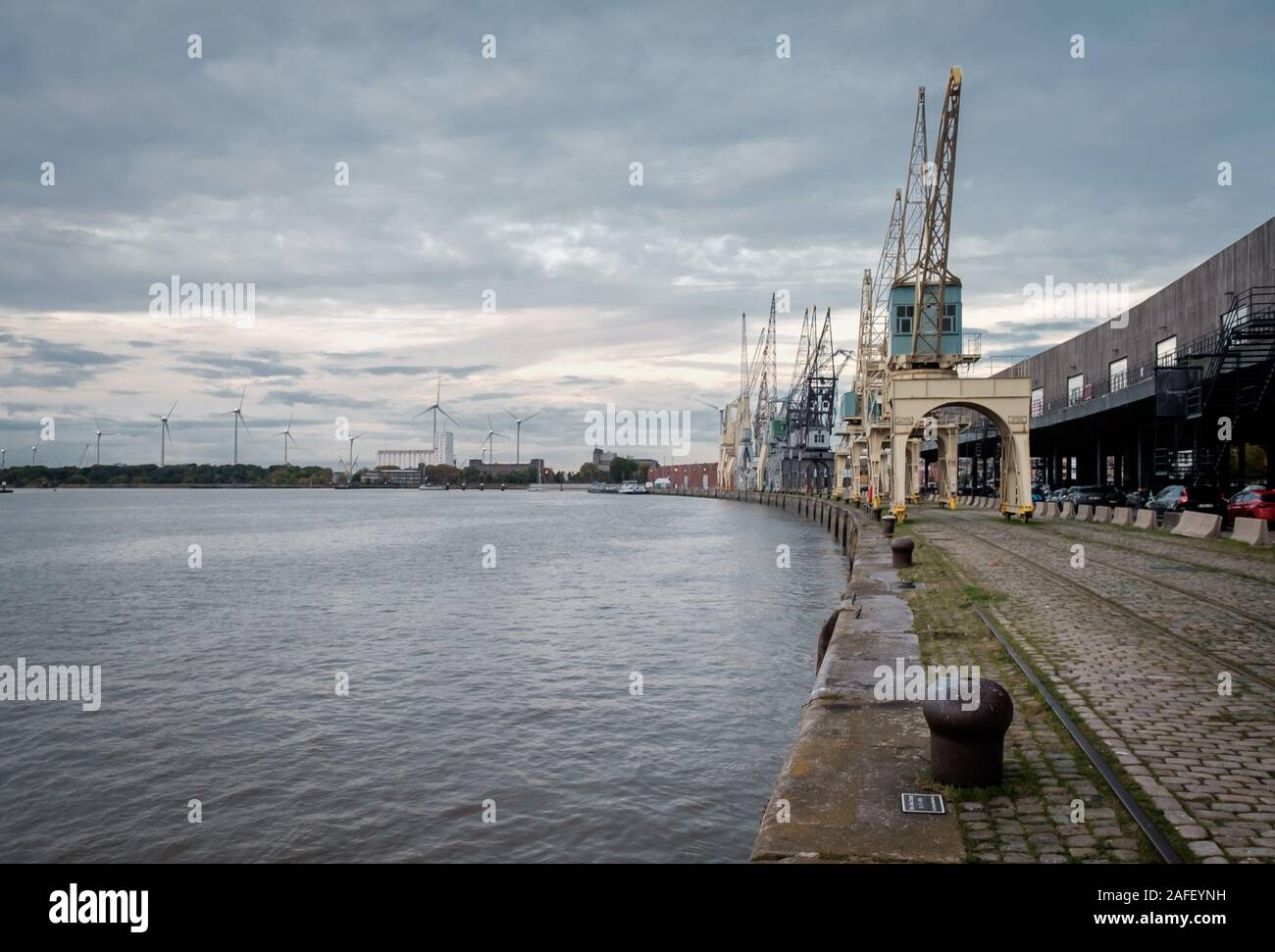 Line-up of old industrial cranes in the center of Antwerp Stock Photo