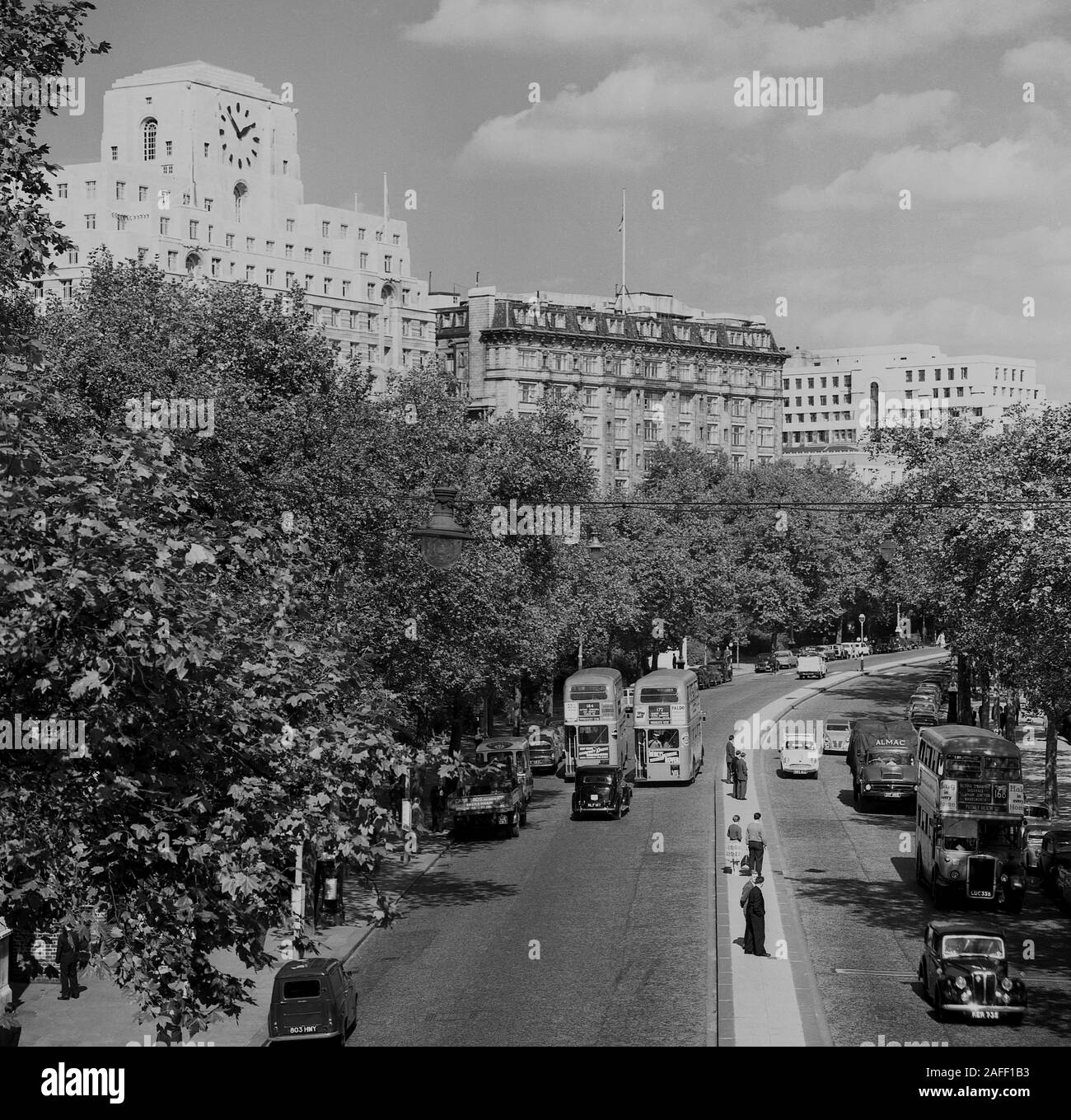 1960s, historical, Victoria Embarkment, London, England, UK, showing the cars and routemaster buses of the era. Overlooking the road, Shelll Mex house. Stock Photo