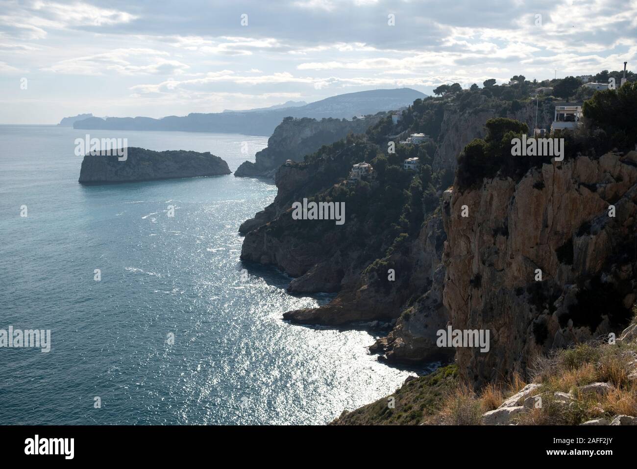 Mediterranean coastline of Jávea with steep cliffs, seaside villas and Descubridor islet from Cabo de la Nao (Xàbia, Marina Alta, Alicante, Spain) Stock Photo
