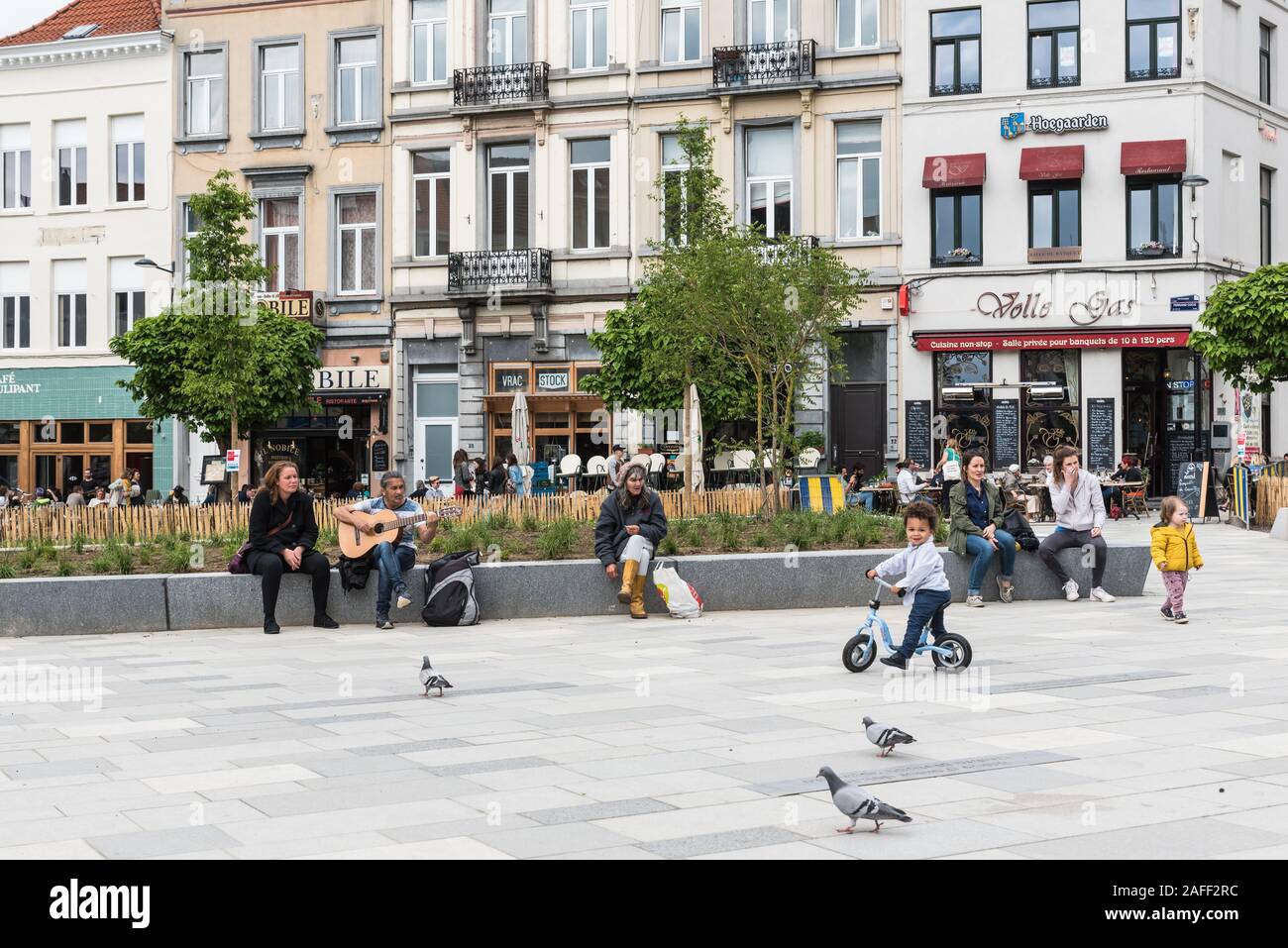 Ixelles, Brussels / Belgium - 05 31 2019: People walking at the new renovated pedestrian zone around Fernand Cocq Square in front of the town hall Stock Photo