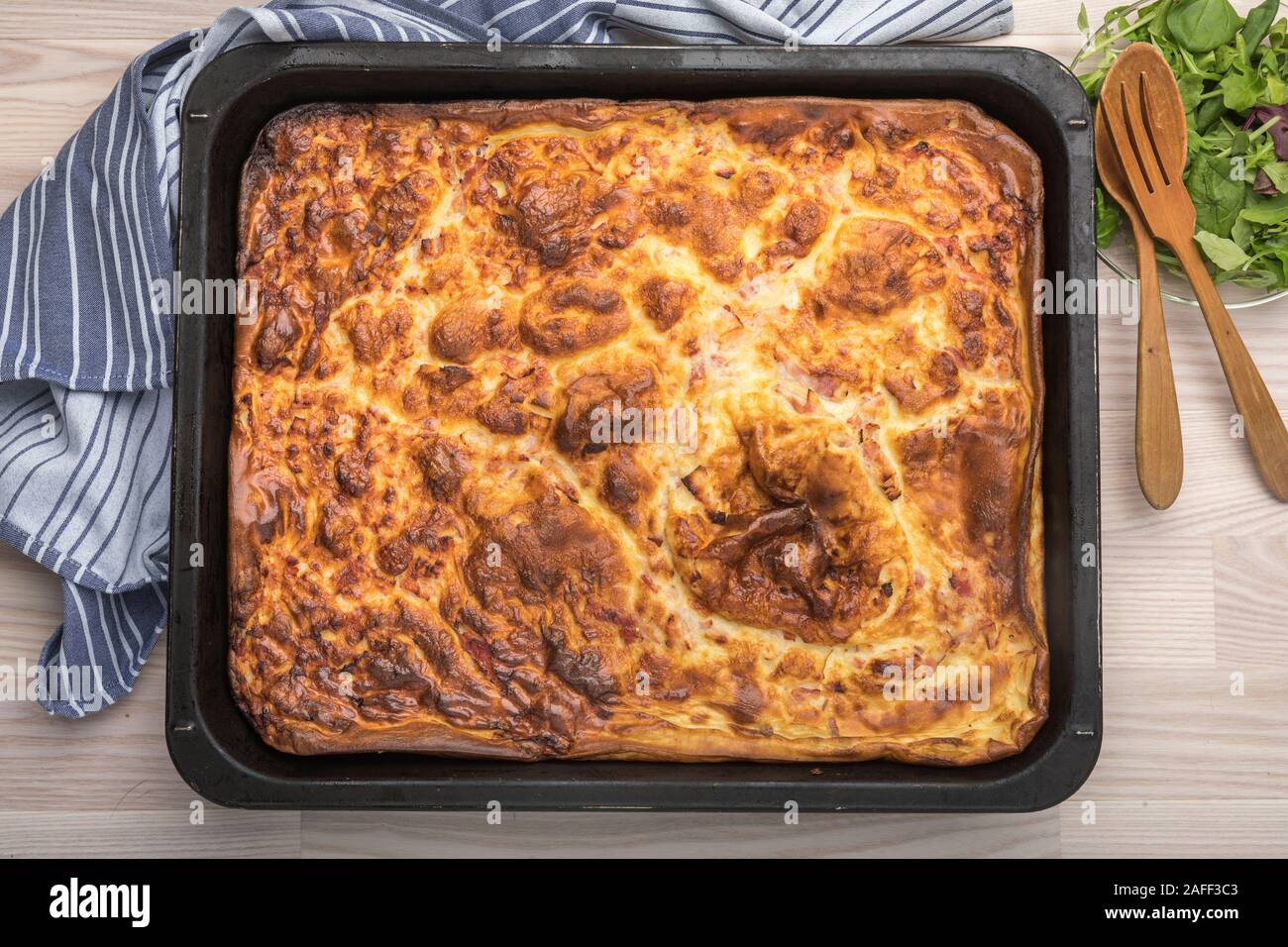 Swedish traditional oven pancake ugnspannkaka with bacon, a kind of batter pudding. Cheap food for families, tasty but low budget food. Seen from abov Stock Photo