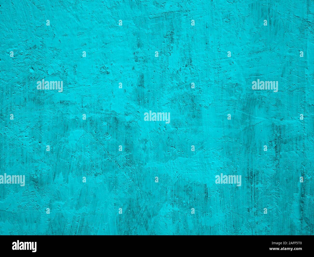 Fragment of solid concrete wall painted in turquoise color with many tine details, close-up Stock Photo