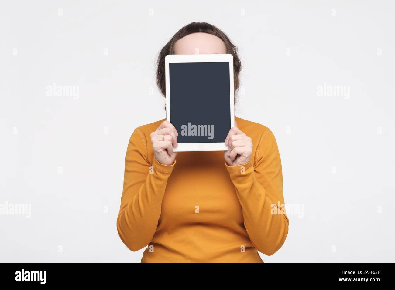 Caucasian woman shows a screen digital tablet. Studio shot Stock Photo ...