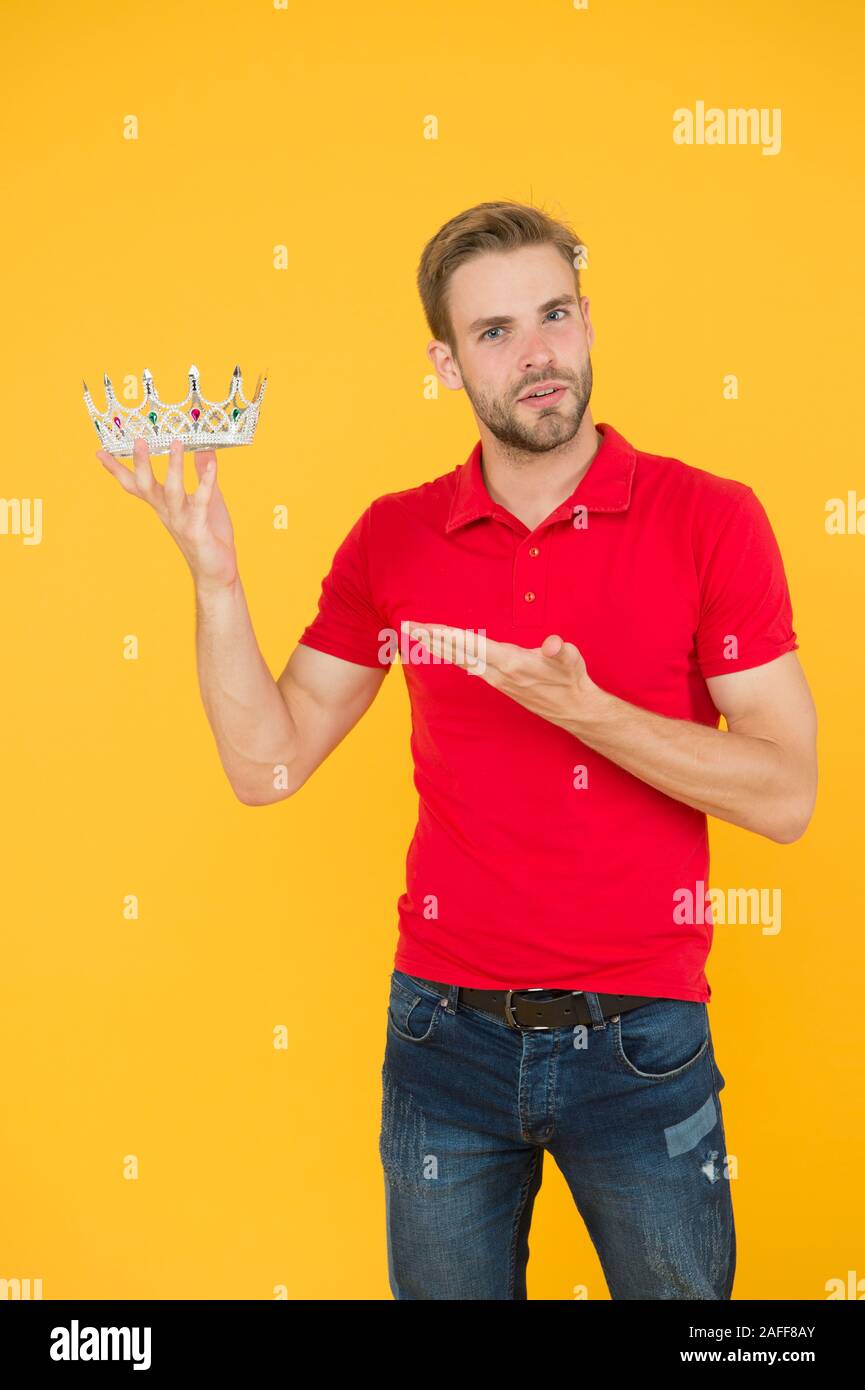 arrogant and self confident man. live in luxury. prom king actually. definitely the best. party king. imagine he is hub of universe. being egoistic. reward for your success. happy man with crown. Stock Photo