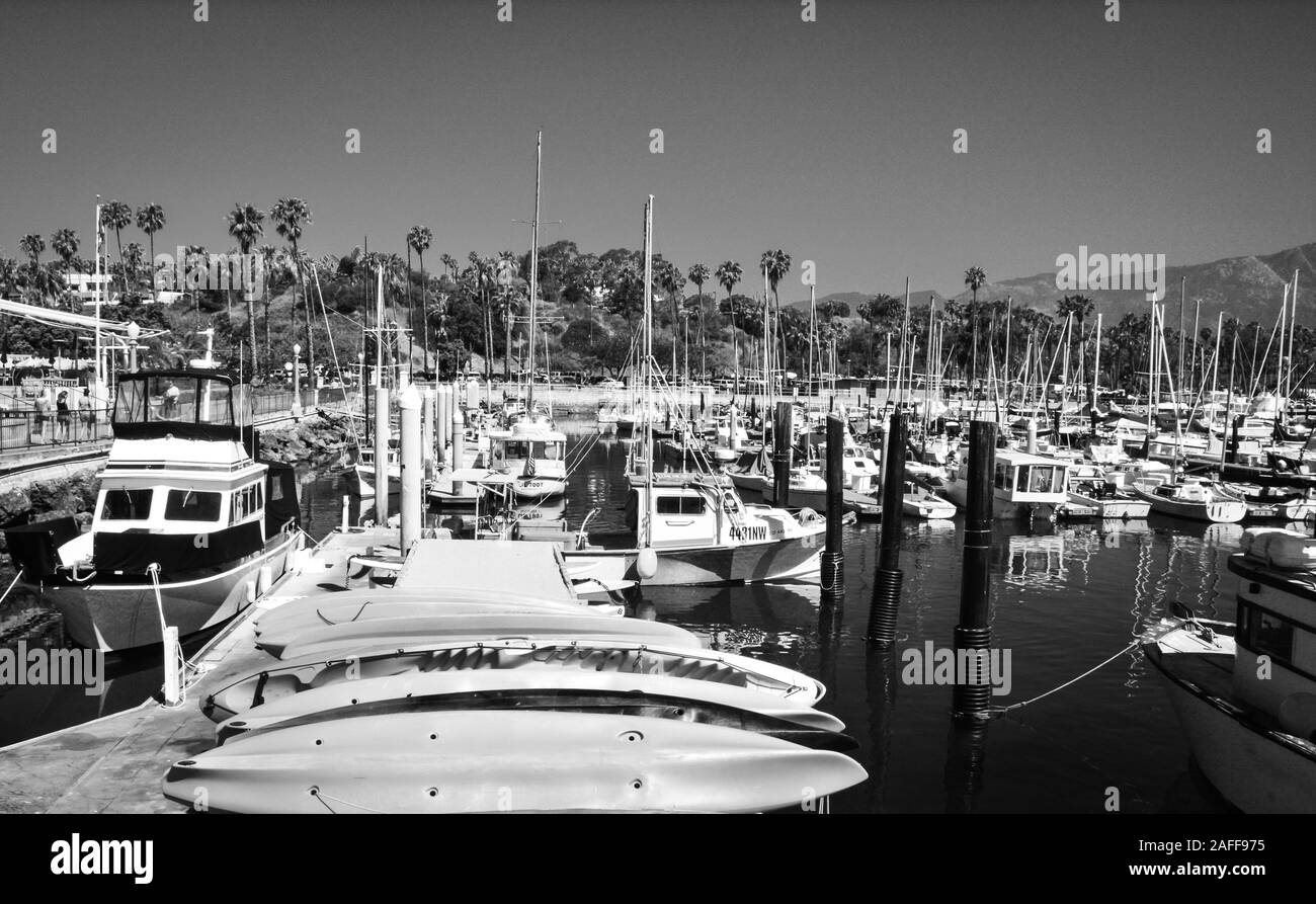 A wonderful California atmosphere to the quaint and vintage feel of the Marina at the Santa Barbara Harbor full of docked boats and kayaks for rent Stock Photo