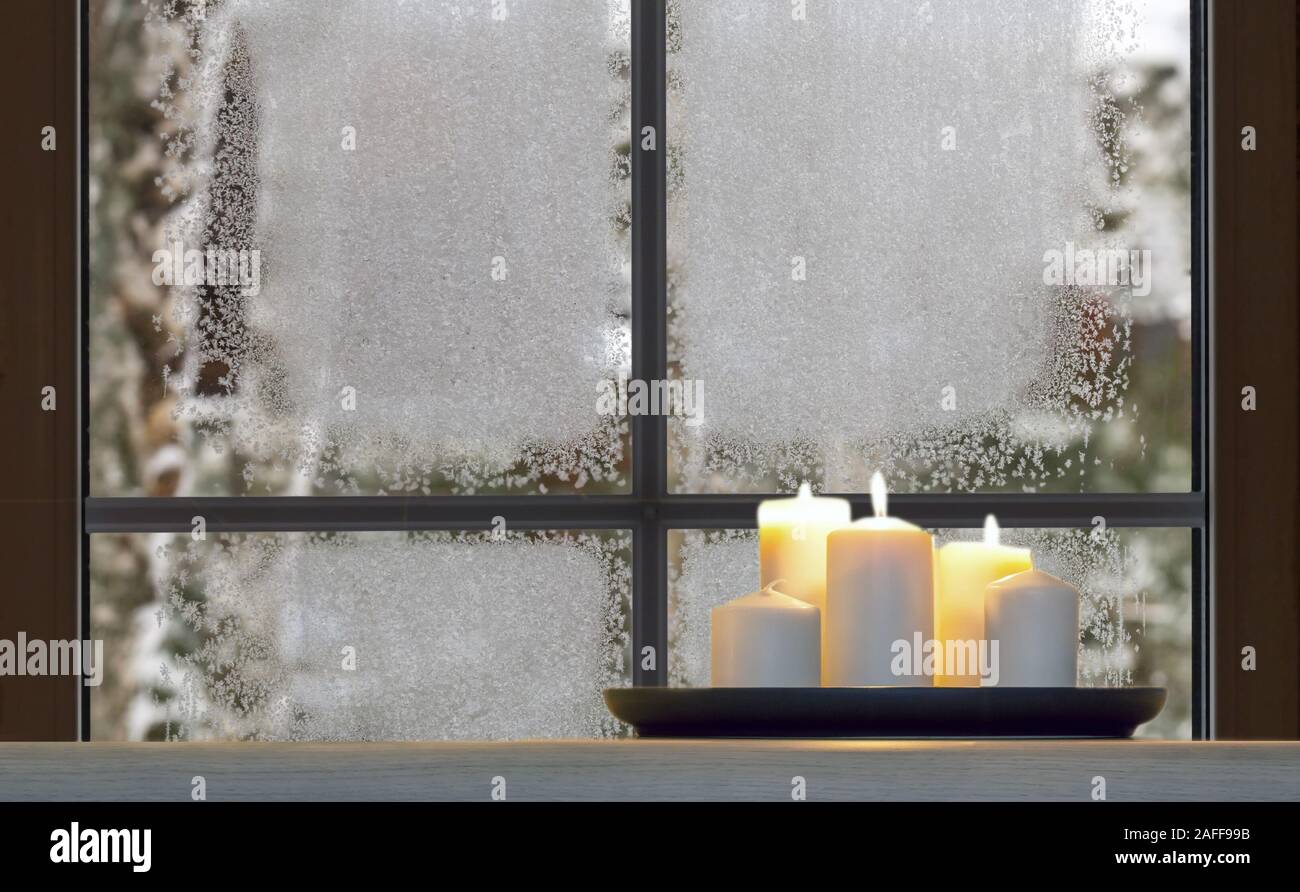 Beautiful Burning Candles And Fairy Lights On Windowsill Indoors