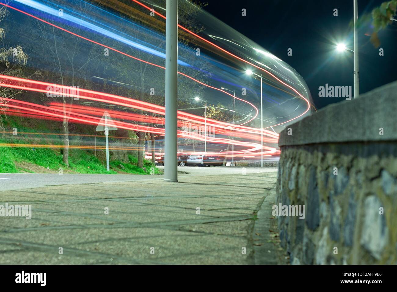 Traffic light trails in a highway with curves close to the spanish city of Toledo Stock Photo