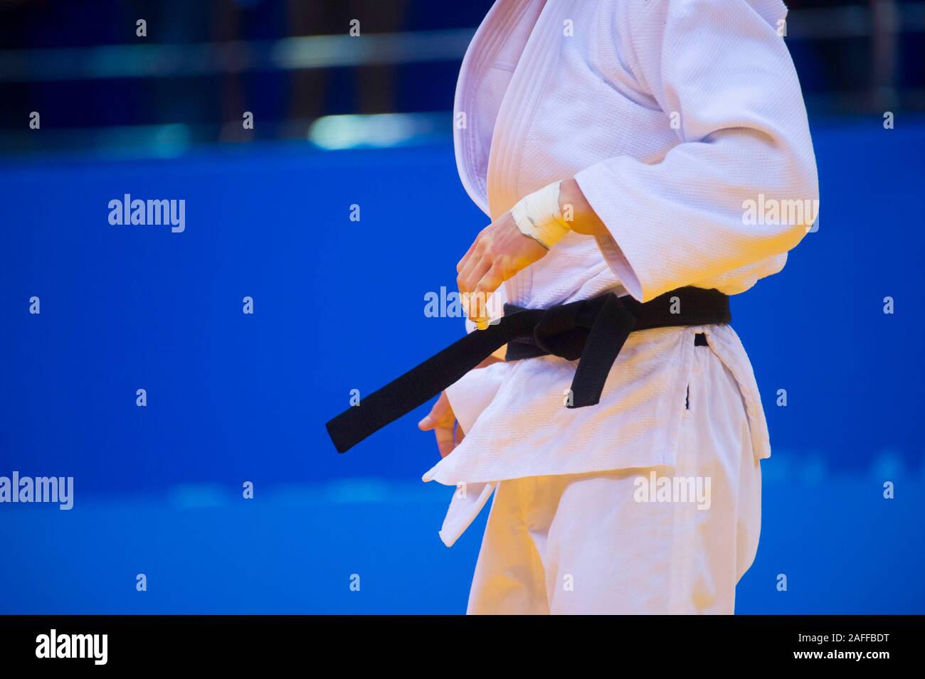 Judo fighter poses in white kimono with black belt. Japanese judo and jiu jitsu Stock Photo Alamy