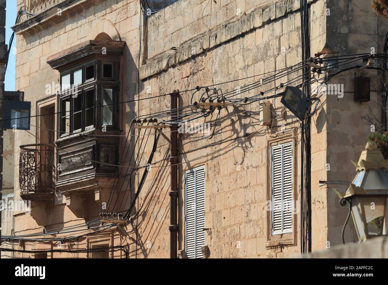 Messy electrical cables on buildings in Malta Stock Photo