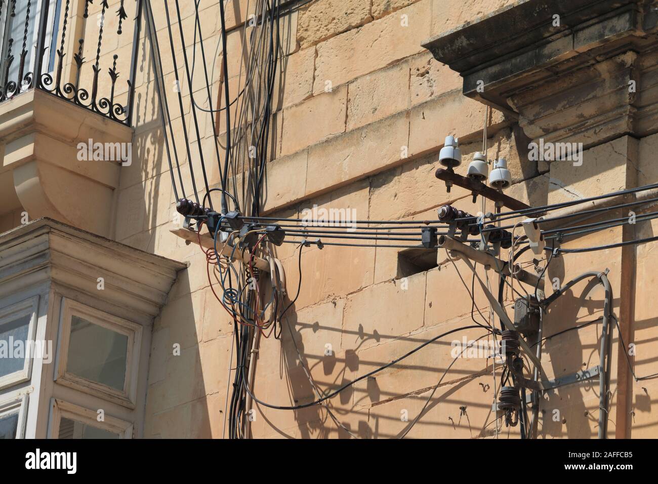 Messy electrical cables on buildings in Malta Stock Photo Alamy