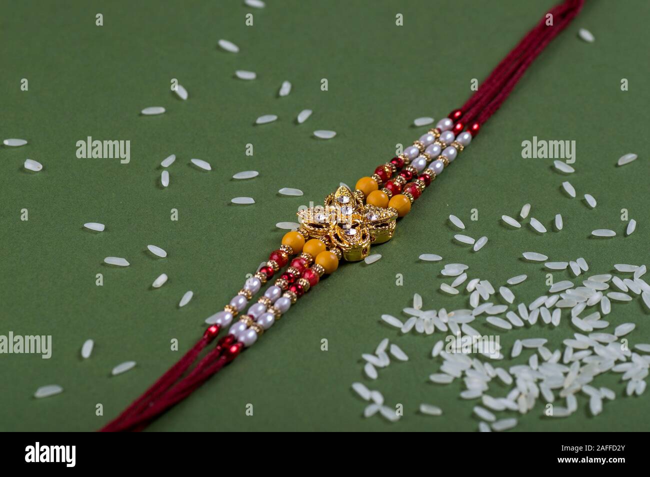 Raksha Bandhan background with an elegant Rakhi. A traditional Indian ...