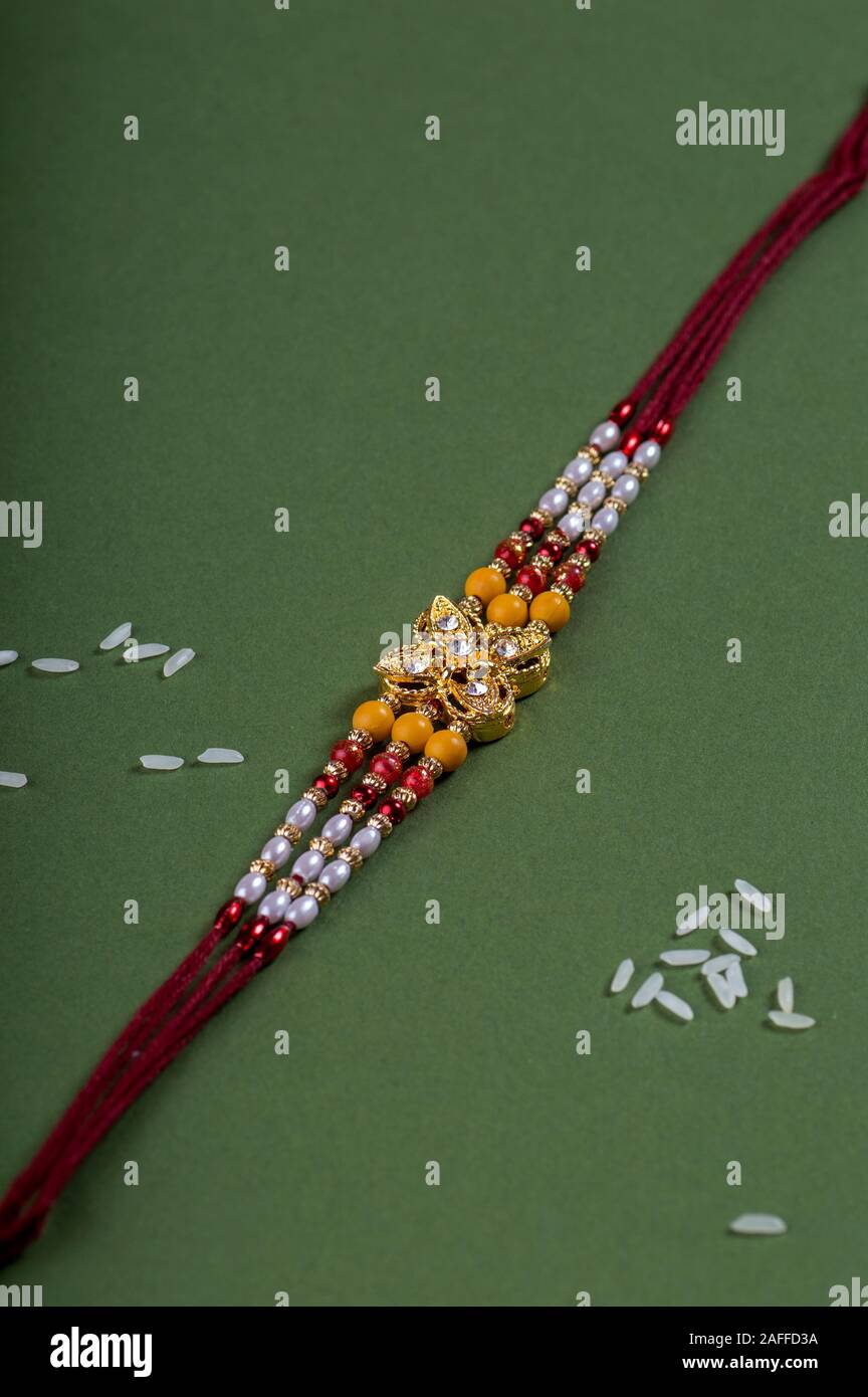 Raksha Bandhan background with an elegant Rakhi. A traditional Indian ...