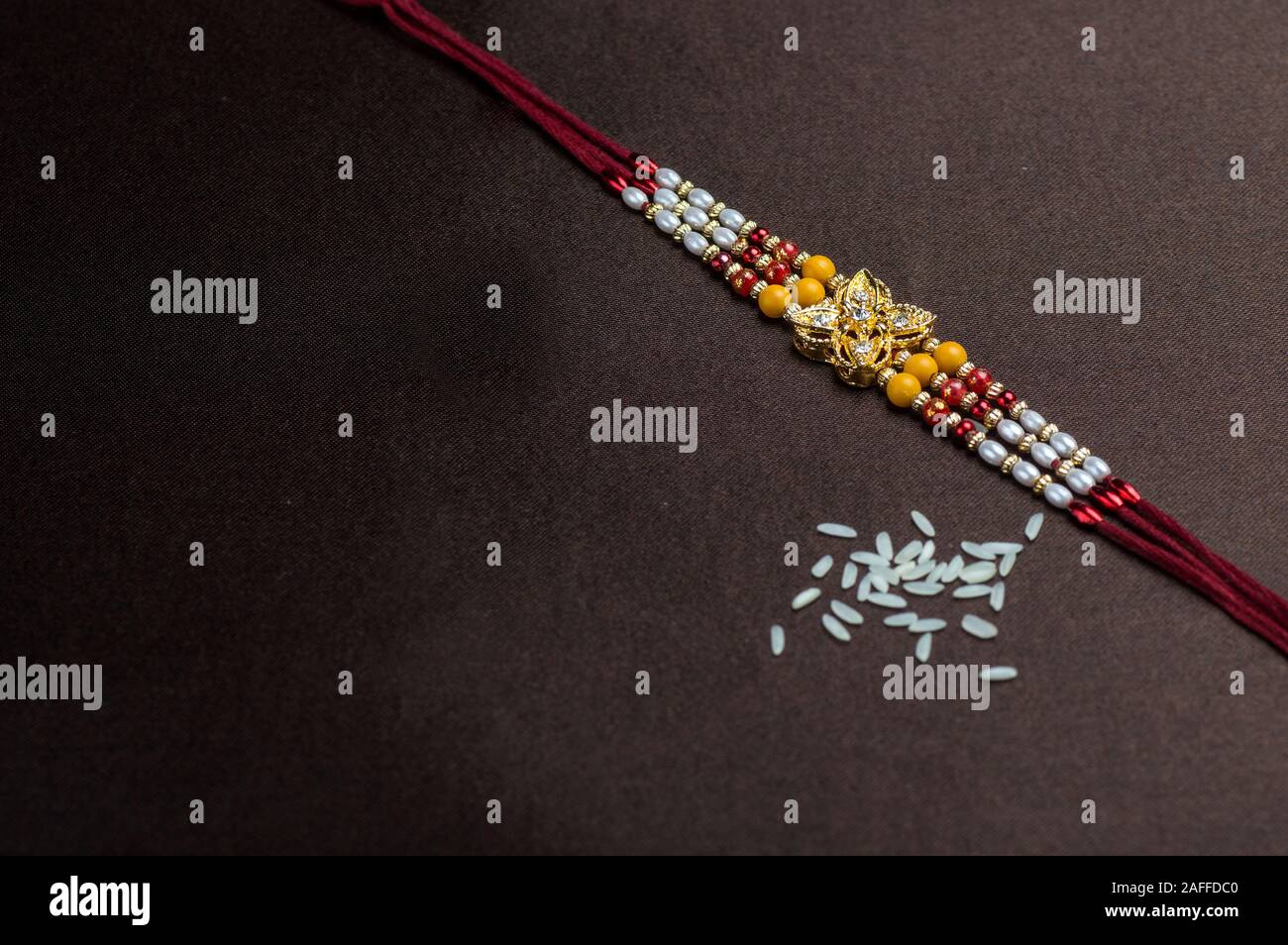 Raksha Bandhan background with an elegant Rakhi. A traditional Indian ...