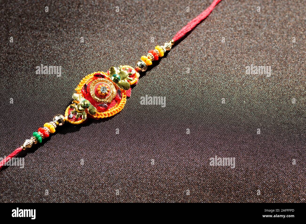 A Rakhi Raksha Bandhan background with an elegant Rakhi. A traditional Indian ...