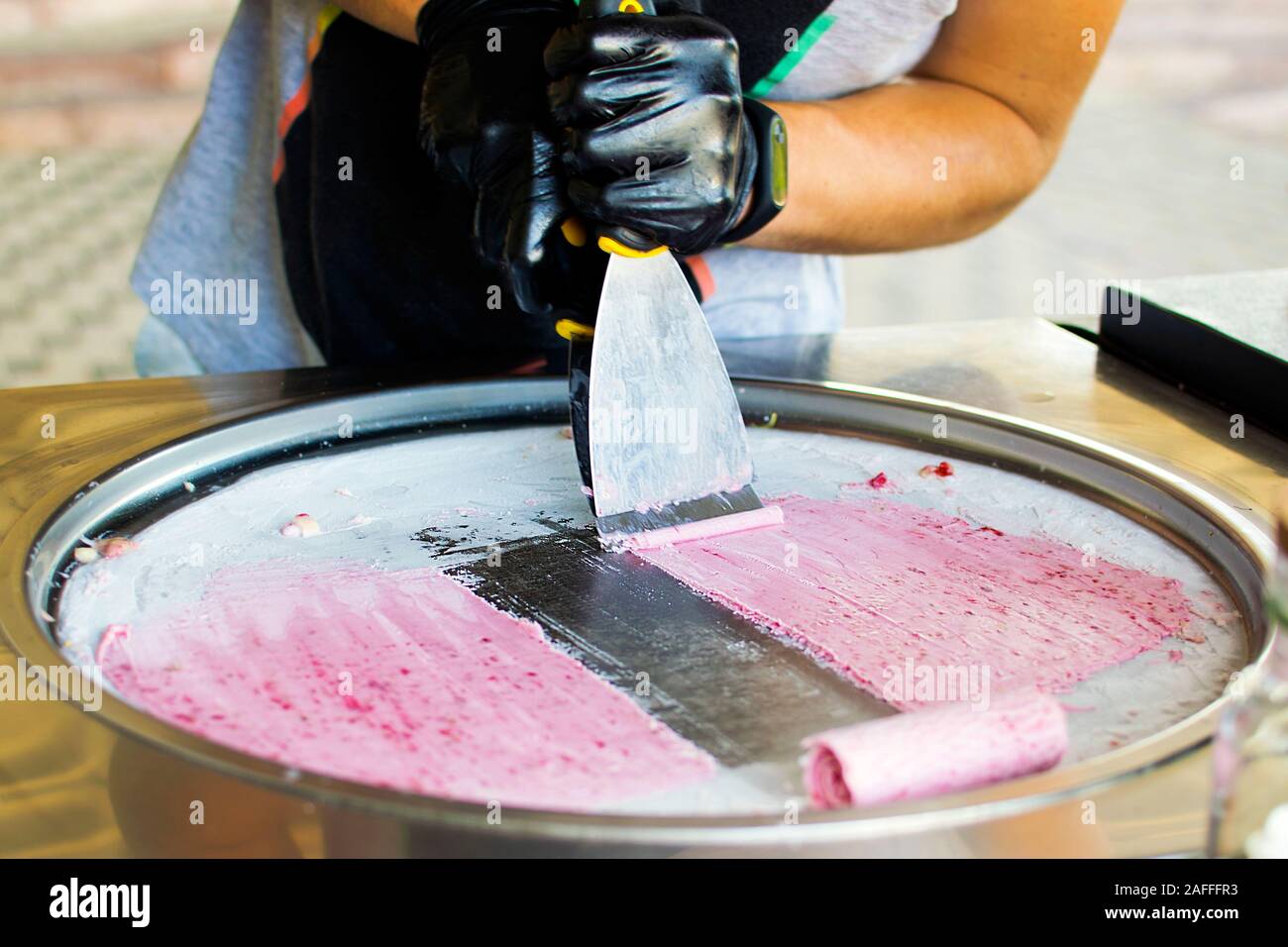 Making rolled ice cream, a Thai street food 