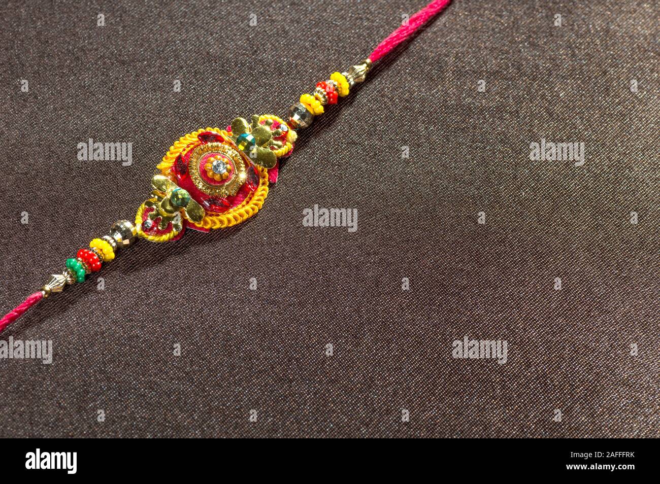 Raksha Bandhan background with an elegant Rakhi. A traditional Indian ...