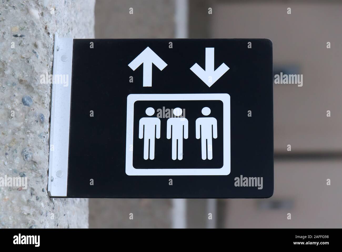 Close up View of Lift (elevator) sign on grey wall background Stock Photo