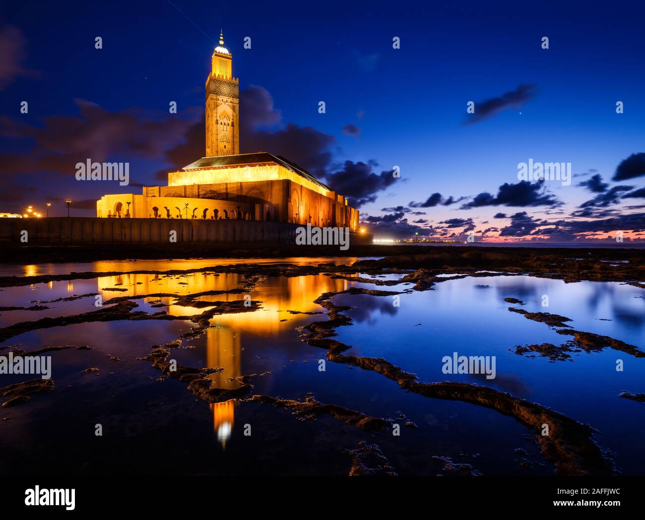 CASABLANCA, MOROCCO - CIRCA APRIL 2018: Mosque  Hassan II in Casablanca at Night as seen from the tidal pools formed by the ocean around it. Stock Photo