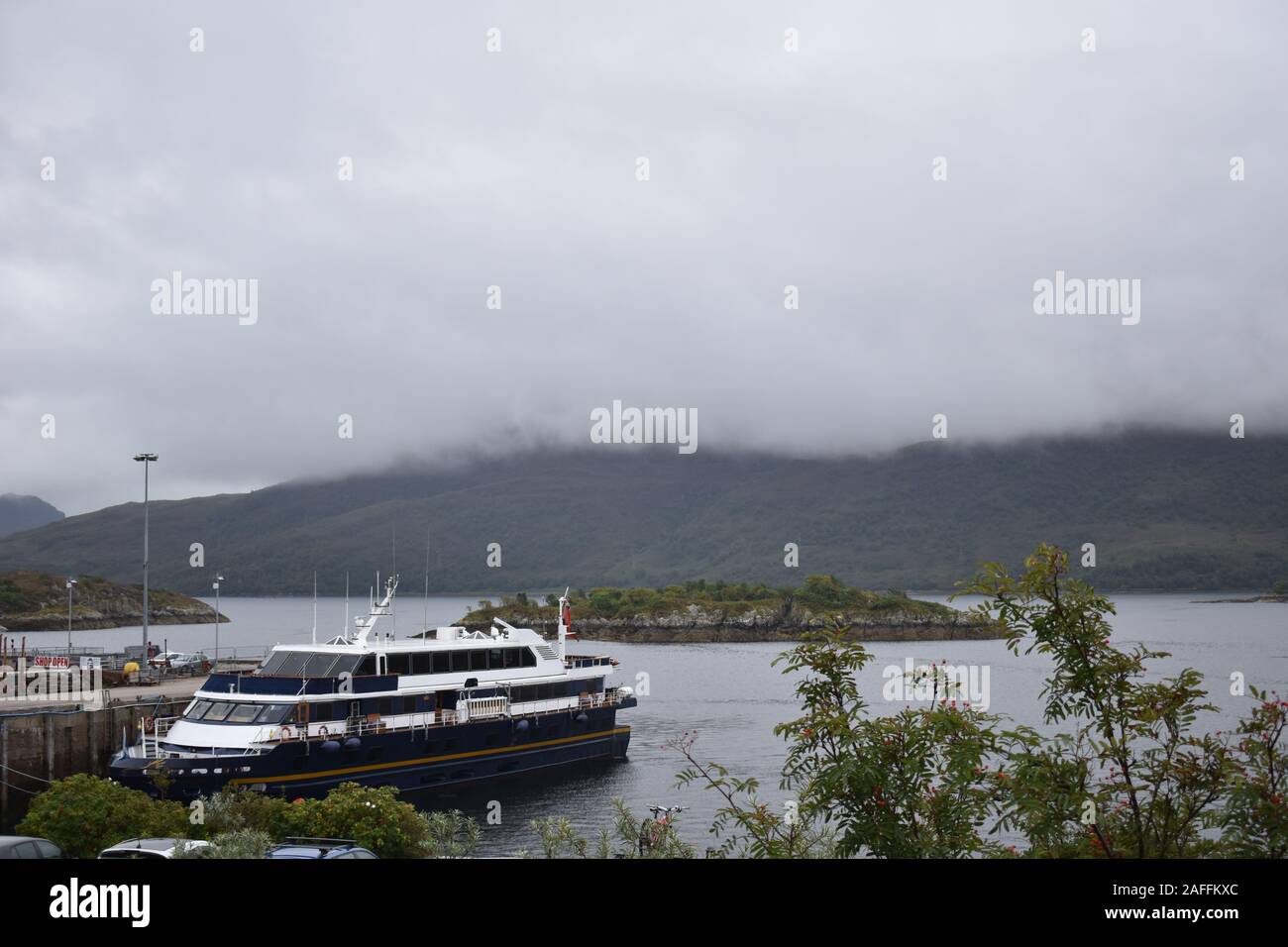 Scenic Loch Ness river cruise boat with sonar equipment departs from Fort Augustus. The day trip includes Fort Augustus Abbey and Cherry Island. Stock Photo