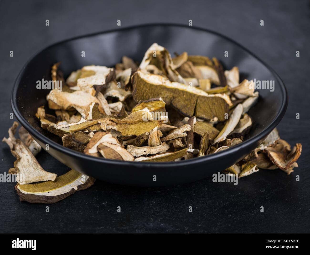 Some Dried Porcinis on a slate slab as detailed closeup shot