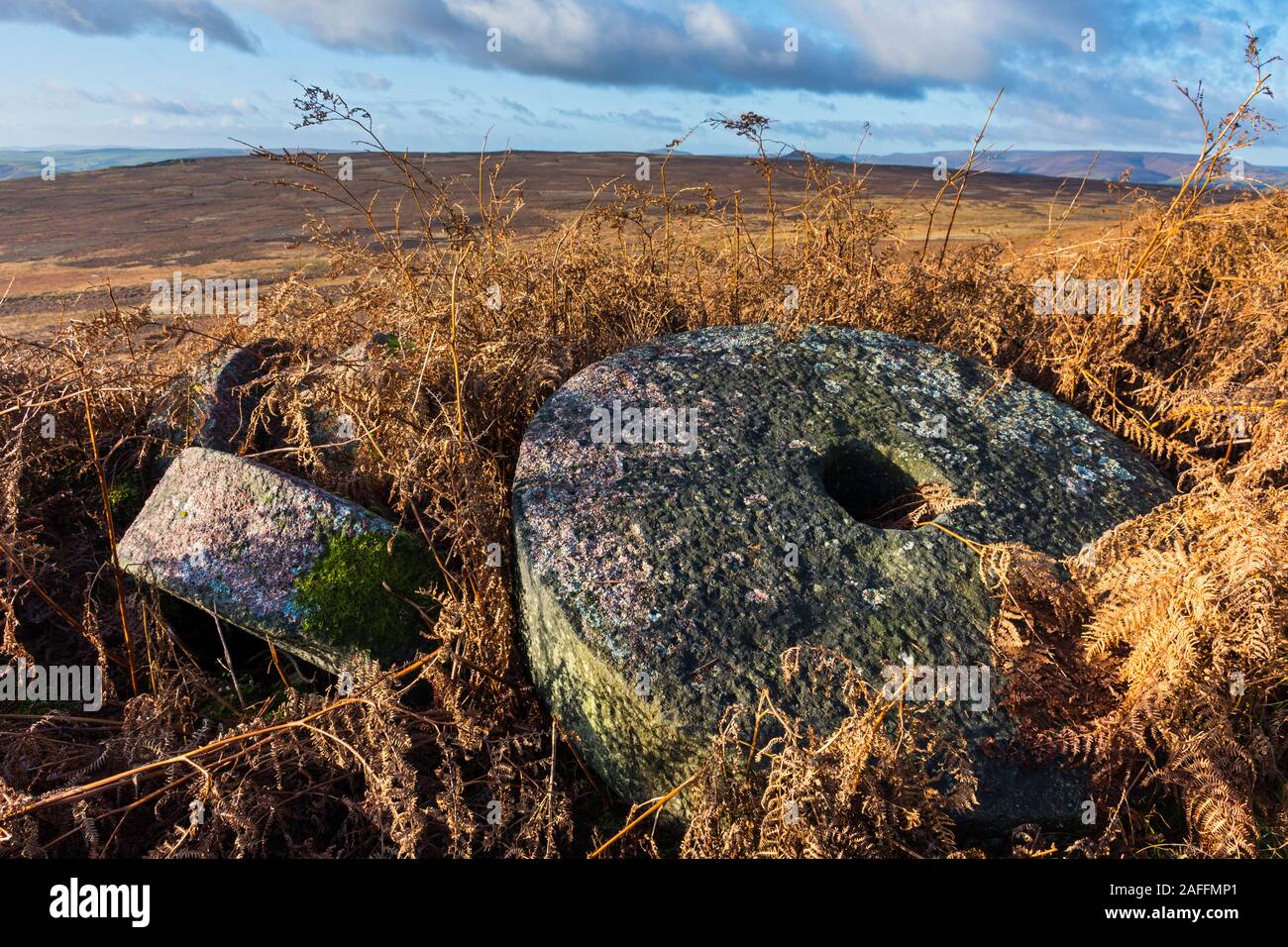 Abandoned millstones from former quarrying, below Stanage Edge. near Hathersage, Peak District, Derbyshire, England, UK. Stock Photo