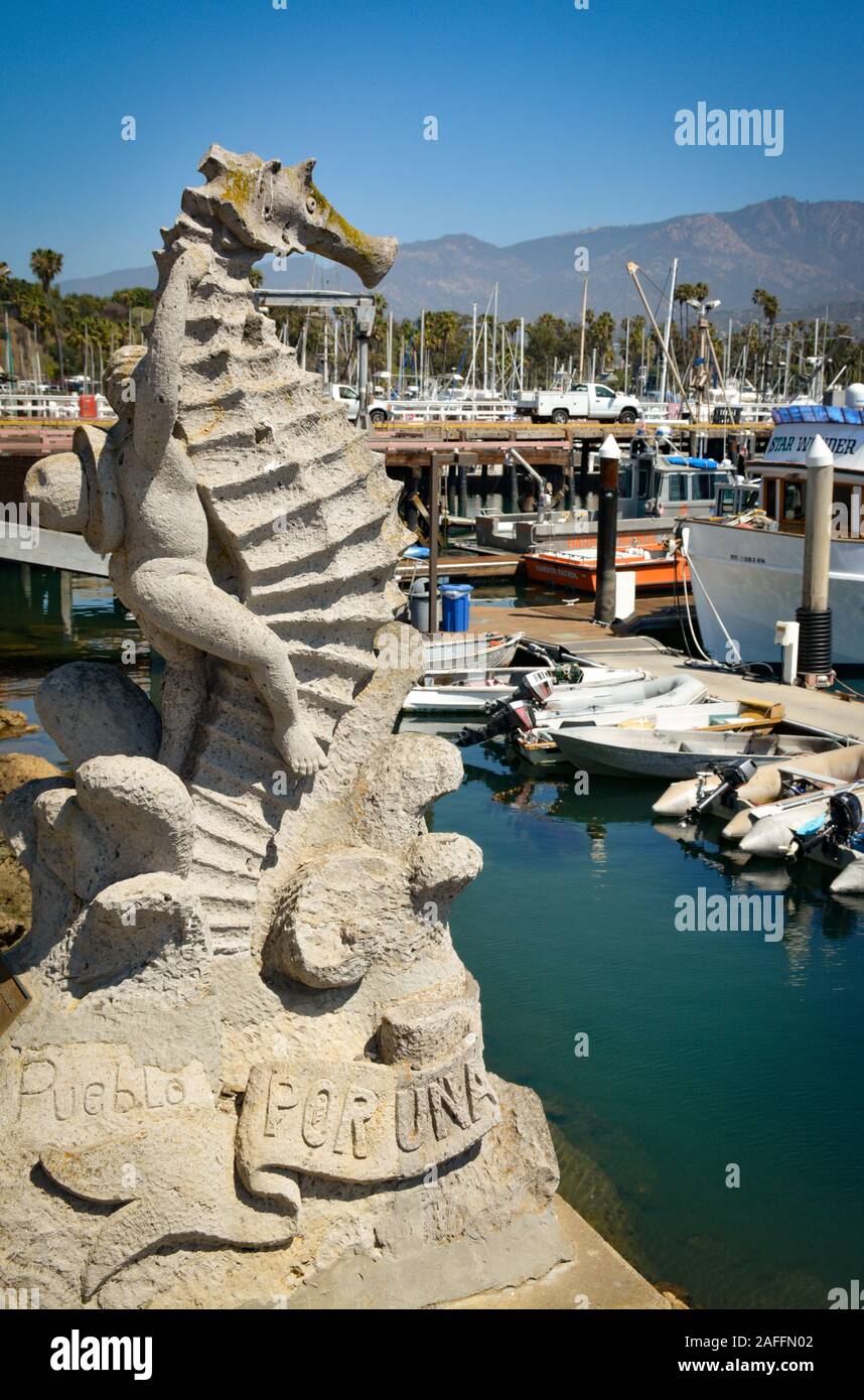 'Boy on a Seashore' stone sculptor, a gift from Puerto Vallarta, MX, overlooks the boat filled marina at the Santa Barbara Harbor in Santa Barbara, CA Stock Photo