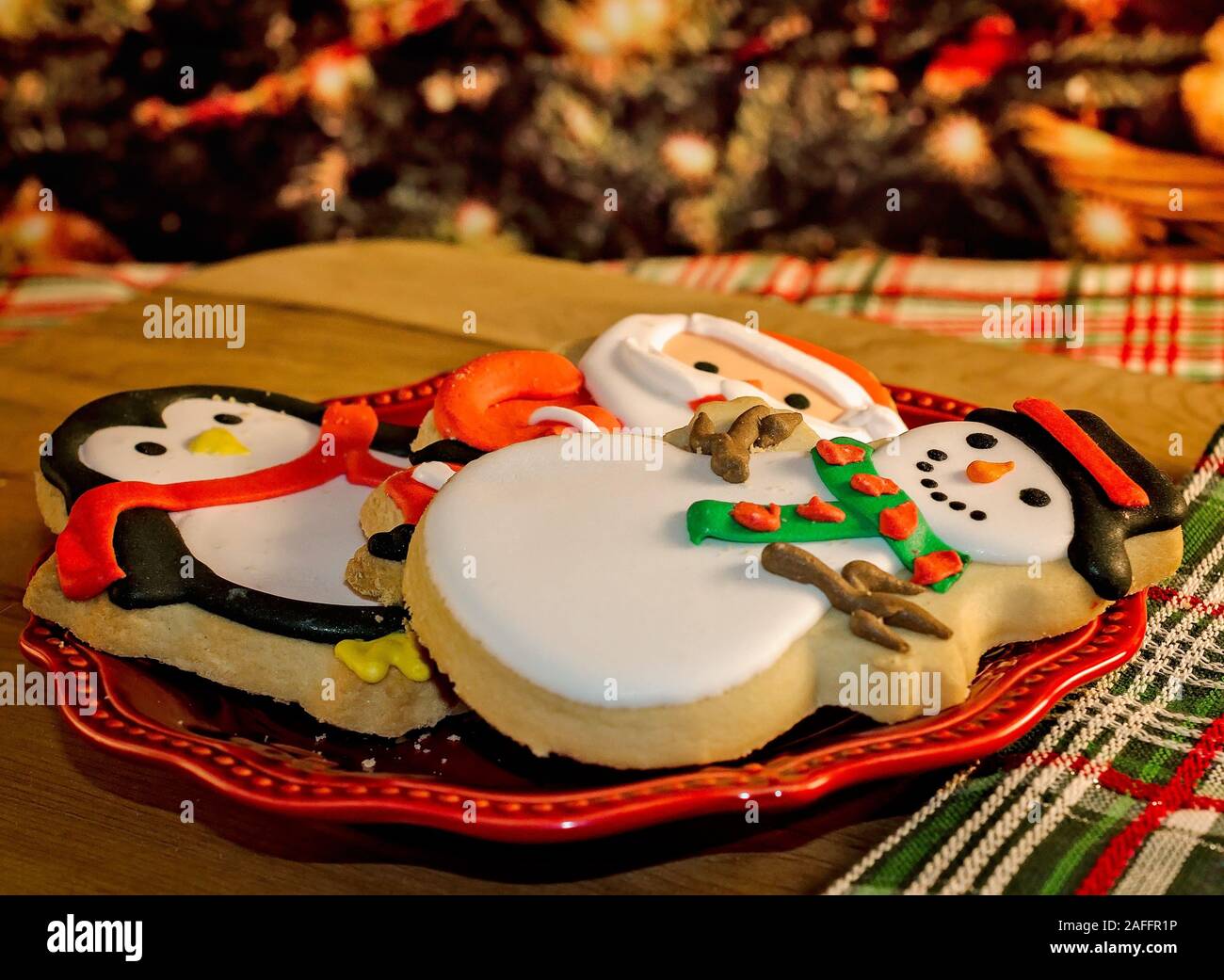 Christmas cookies are pictured on a red plate beside a Christmas tree, January 7, 2017, in Coden, Alabama. Stock Photo