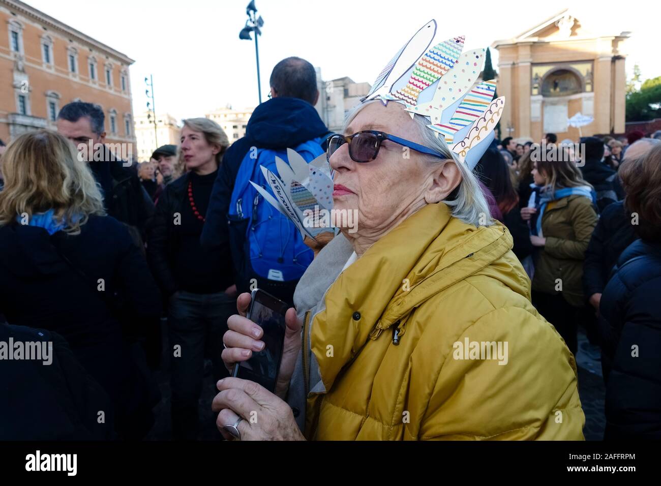 Rome, Italy. 14th Dec, 2019. Elderly woman attends the Global Sardine Day event. More than 40.000 supporters came to Saint John Square to show their support for “6000 Sardines”, an anti-populist left-wing movement, to express their opposition to populist forces. The spontaneous pacifist and antifascists movement is against the League Party and the far-right. Rome, Italy, Europe, EU. Stock Photo