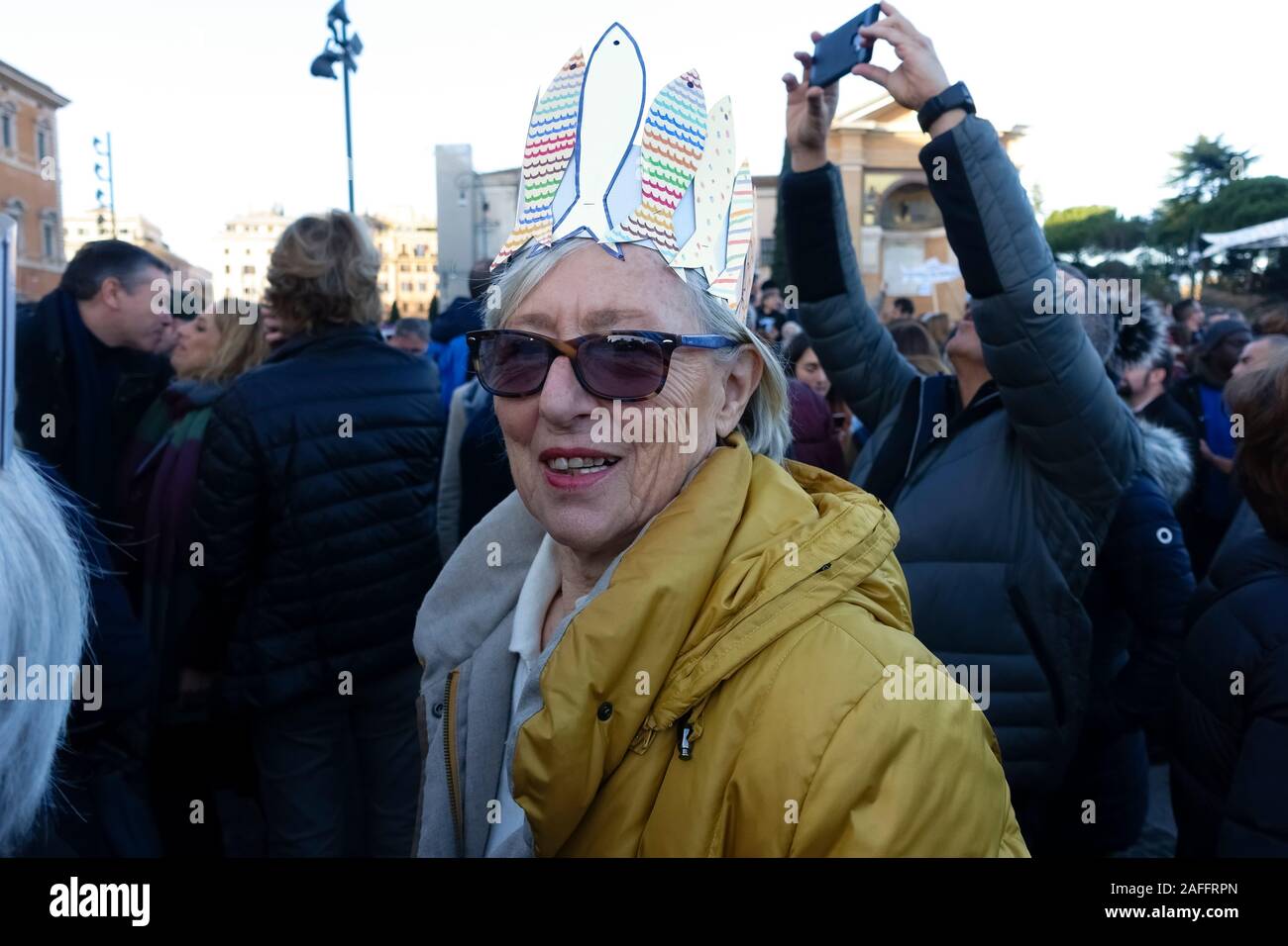 Rome, Italy. 14th Dec, 2019. Elderly woman attends the Global Sardine Day event. More than 40.000 supporters came to Saint John Square to show their support for “6000 Sardines”, an anti-populist left-wing movement, to express their opposition to populist forces. The spontaneous pacifist and antifascists movement is against the League Party and the far-right. Rome, Italy, Europe, EU. Stock Photo