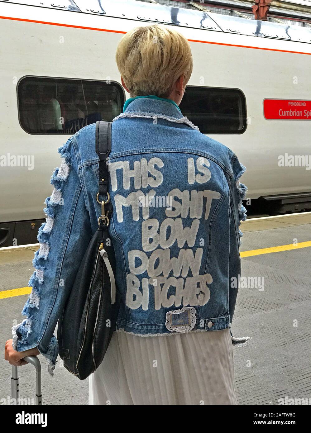 Girl on station,WCML,West Coast Main Line,wearing a ,This is My Shit,Bow Down Bitches, jacket - Bow Down / I Been On Stock Photo