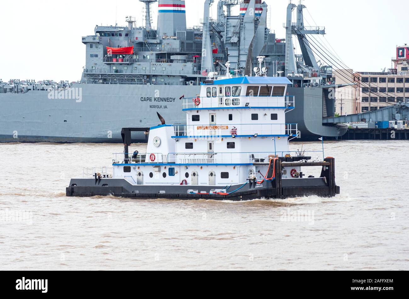 New Orleans, LA/USA – June 14, 2019: Roll on/ roll off cargo carrier operated by United States Navy’s Sealift Command and towboat on Mississippi River Stock Photo