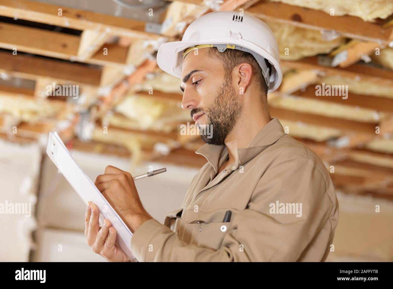 smart pensive builder thinking about something indoors Stock Photo