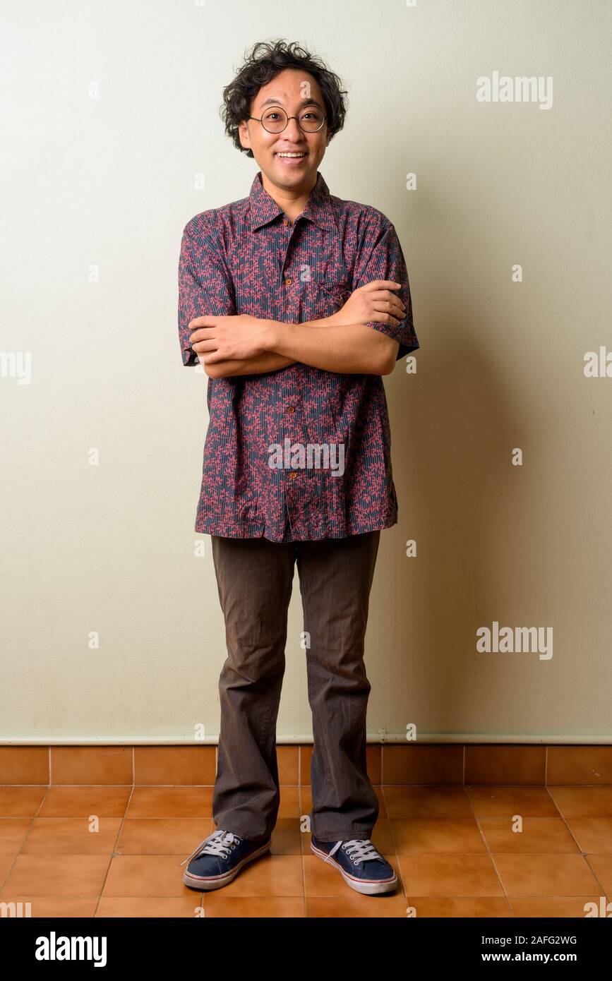 Full body shot of happy Japanese man smiling with arms crossed Stock ...