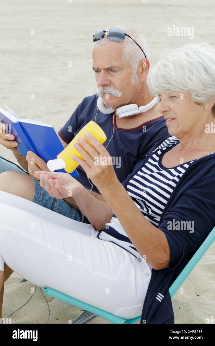 couple relaxing on the beach Stock Photo - Alamy