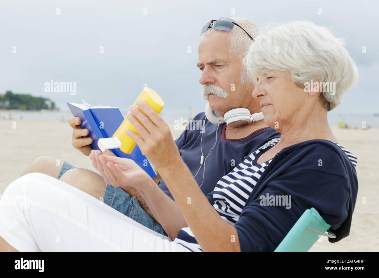 couple relaxing on the beach Stock Photo - Alamy