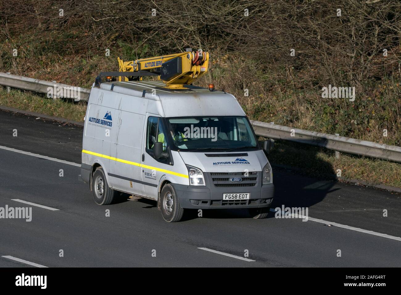 Altitude services working at height high access driving on the M61 near Manchester, UK Stock Photo