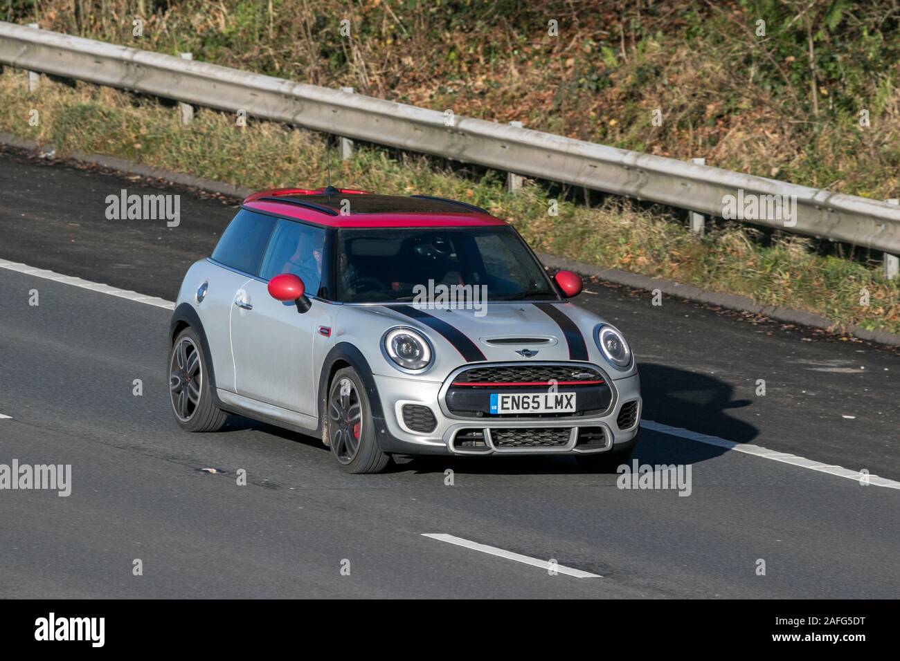 2015 silver Mini John Cooper Works Auto; driving on the M61 motorway near Manchester, UK Stock Photo