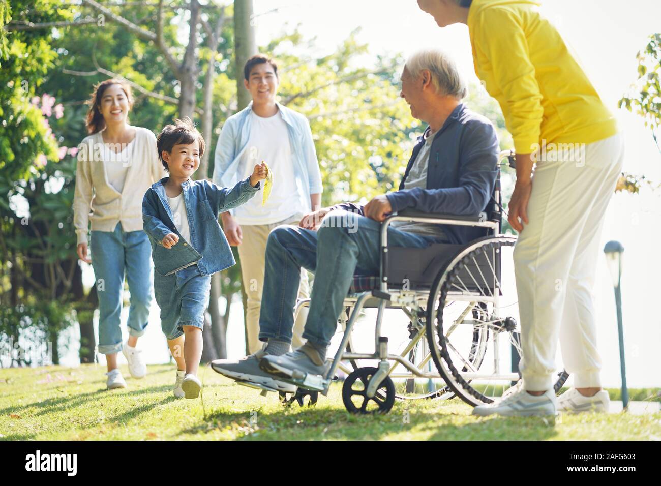 young asian couple and child visiting grandparents in nursing home Stock Photo