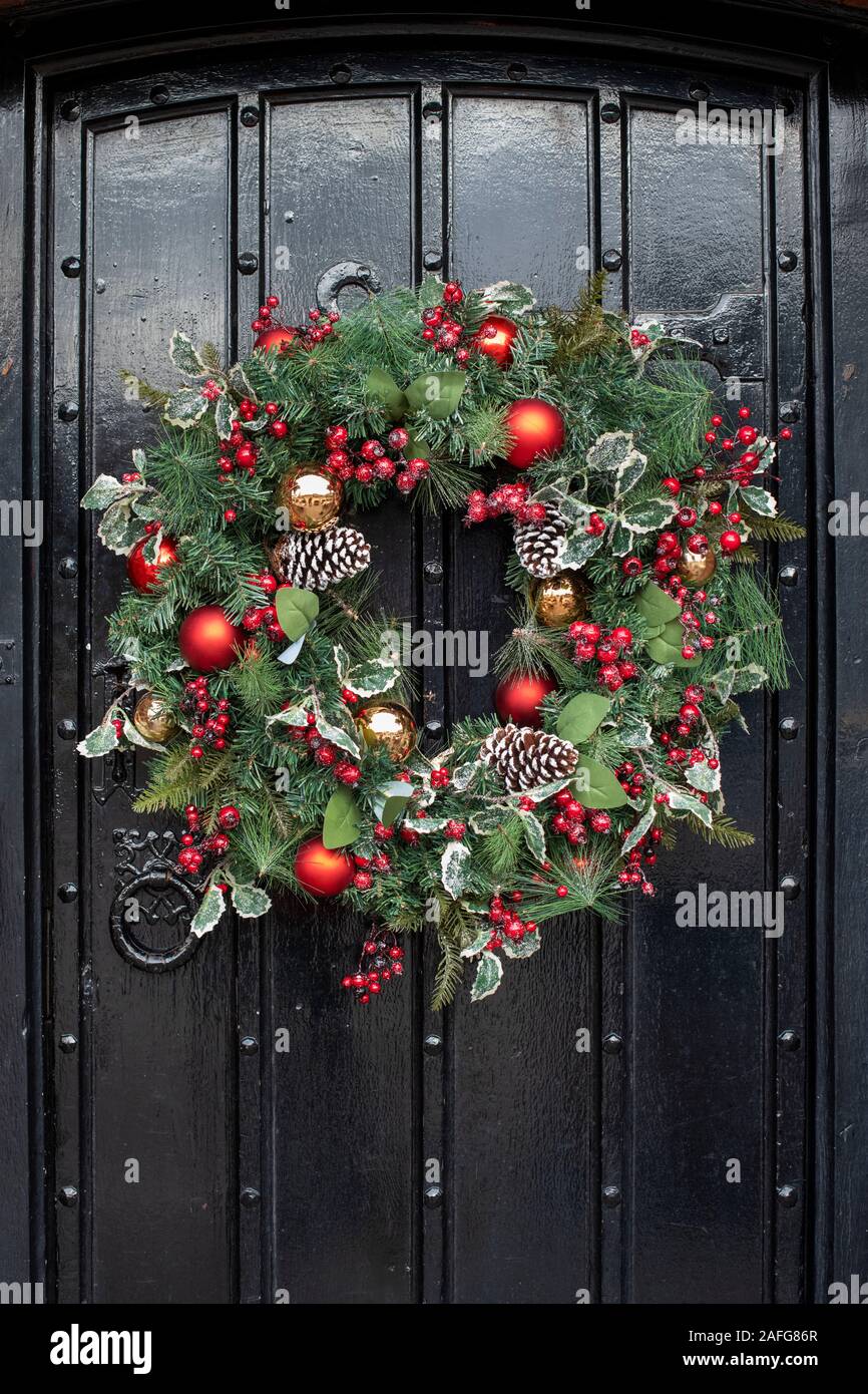 Christmas wreath on an old wooden black door in Stratford Upon Avon, Warwickshire, England Stock Photo