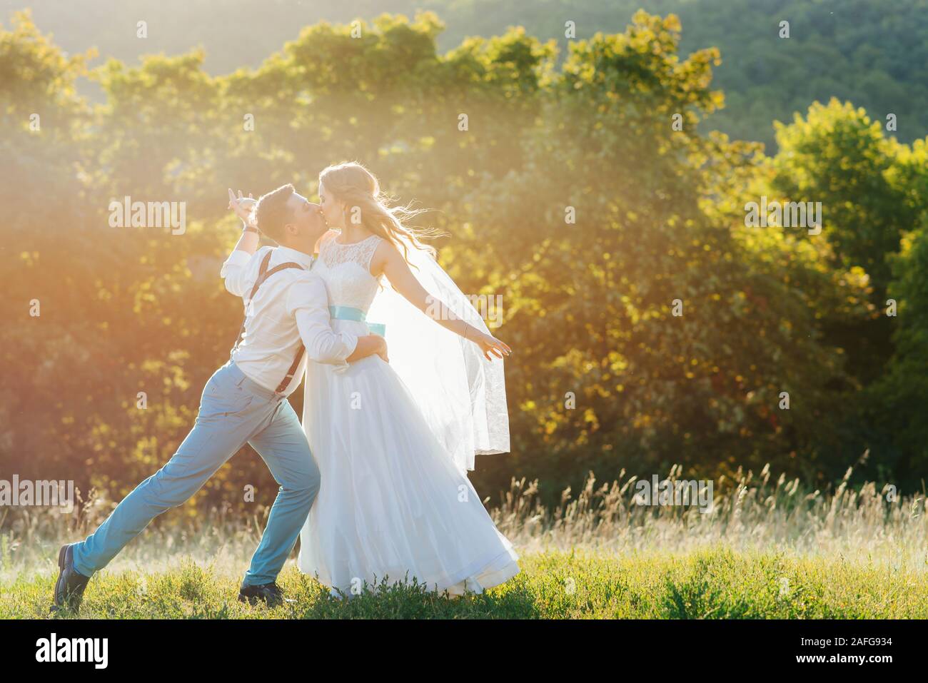 the bride and groom are photographed at sunset Stock Photo - Alamy
