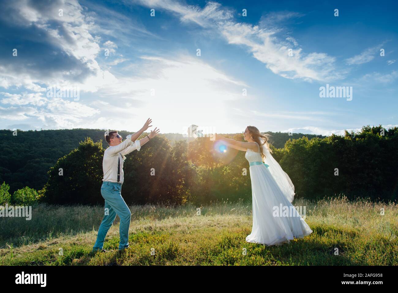 the bride and groom are photographed at sunset Stock Photo - Alamy