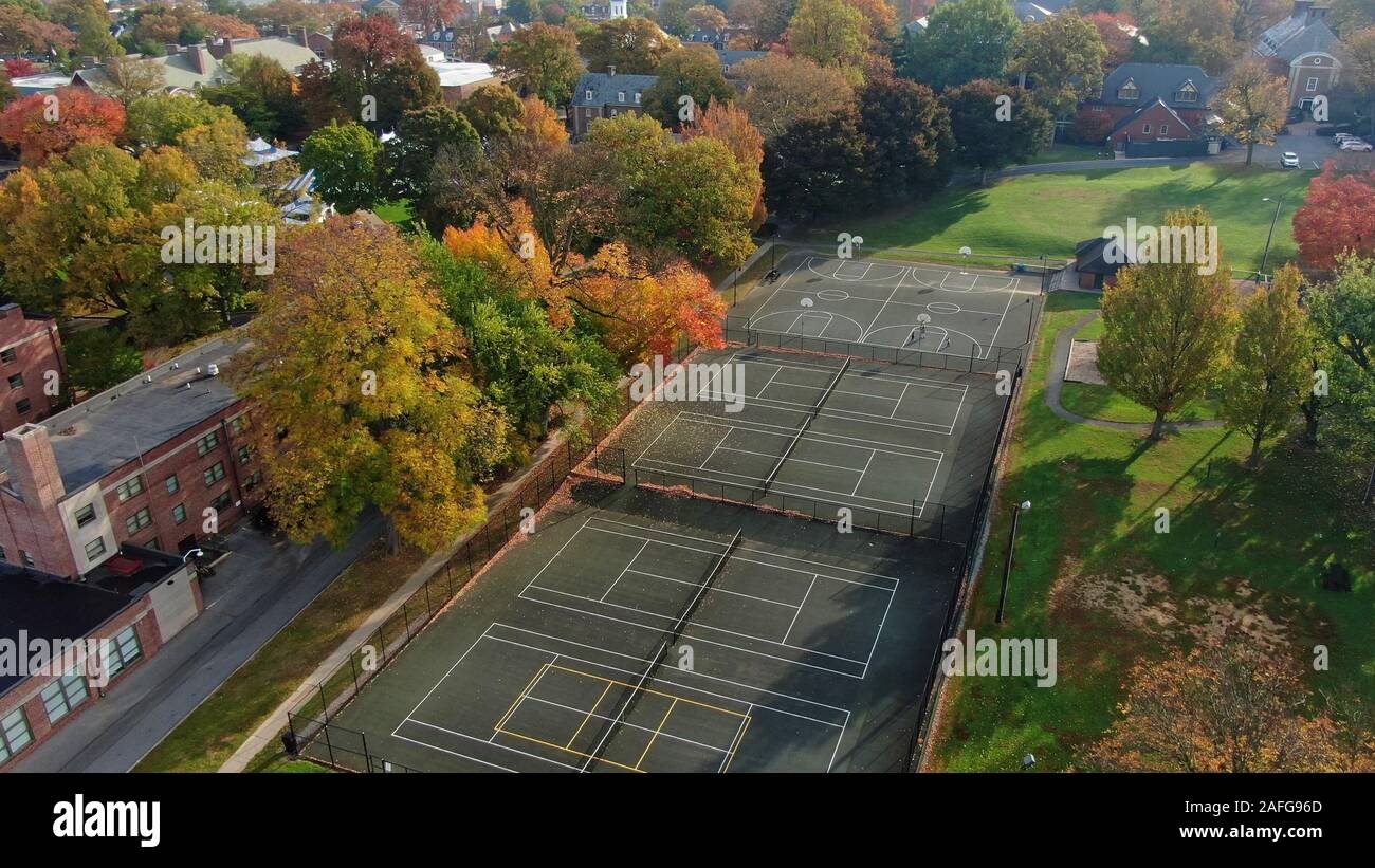 Playground and public park with trees in colourful autumn foliage in