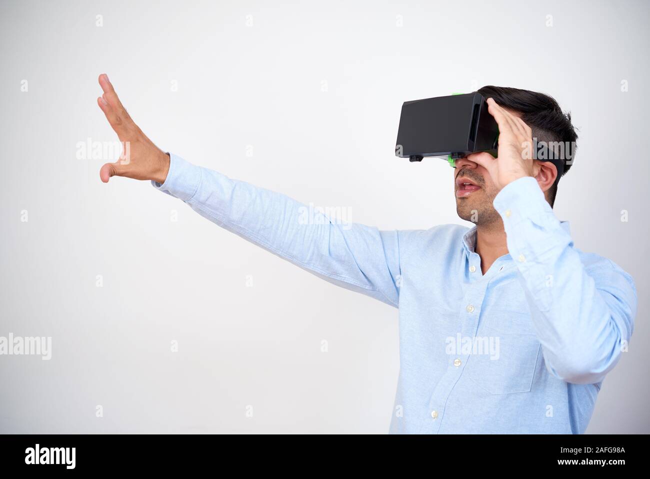 Businessman using virtual reality headset when working on presentation for ambitious project Stock Photo